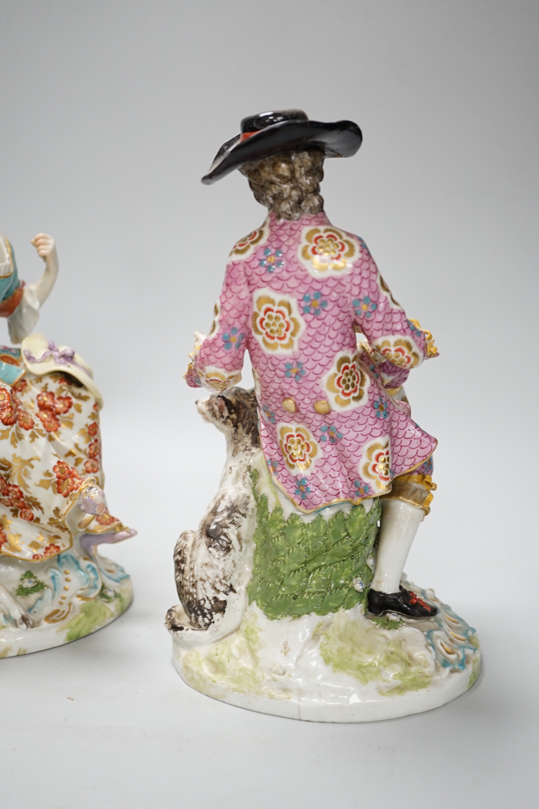 A pair of Chelsea Derby figures, seated male and female, 27.5cm